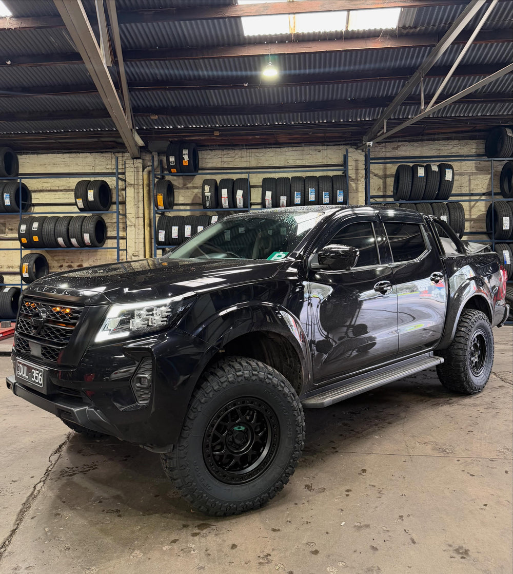 Black Nissan Navara on off-road wheels and tyres