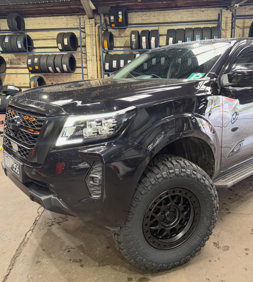 Black Nissan Navara on off-road wheels and tyres