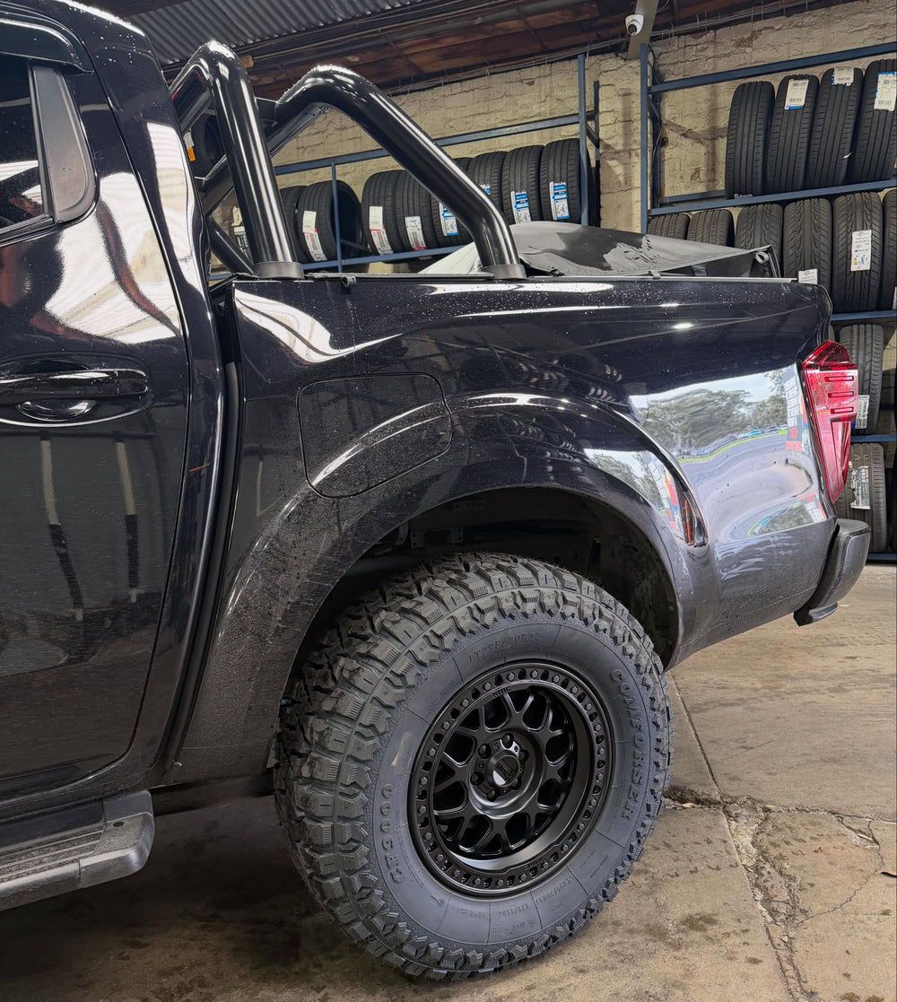Black Nissan Navara on off-road wheels and tyres